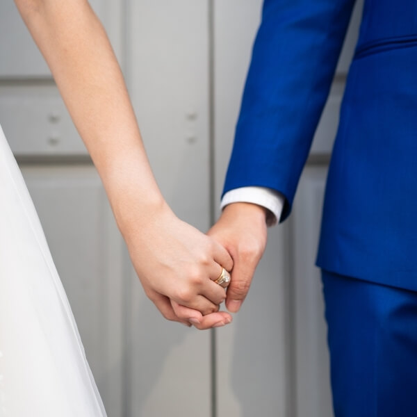 bride and groom holding hands