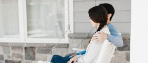 husband and wife on porch swing