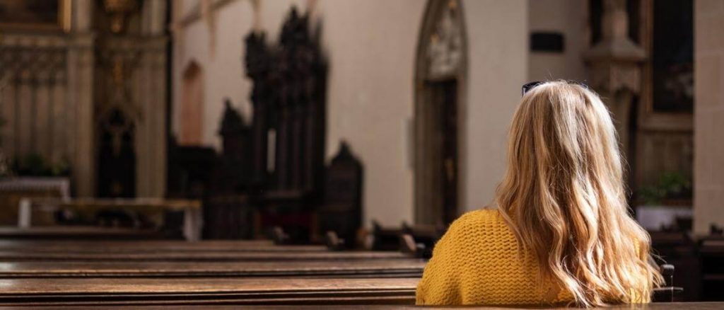 young woman sitting in church