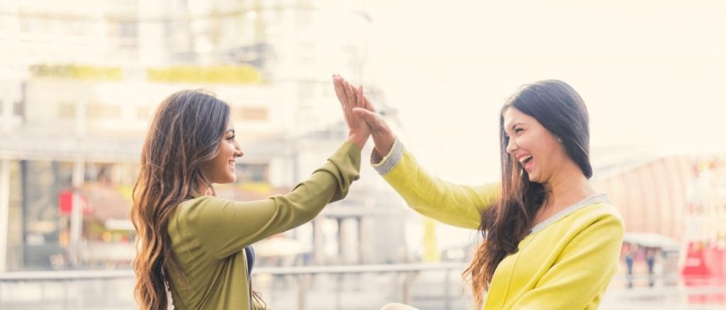 Two women high-fiving