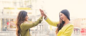 Two women high-fiving