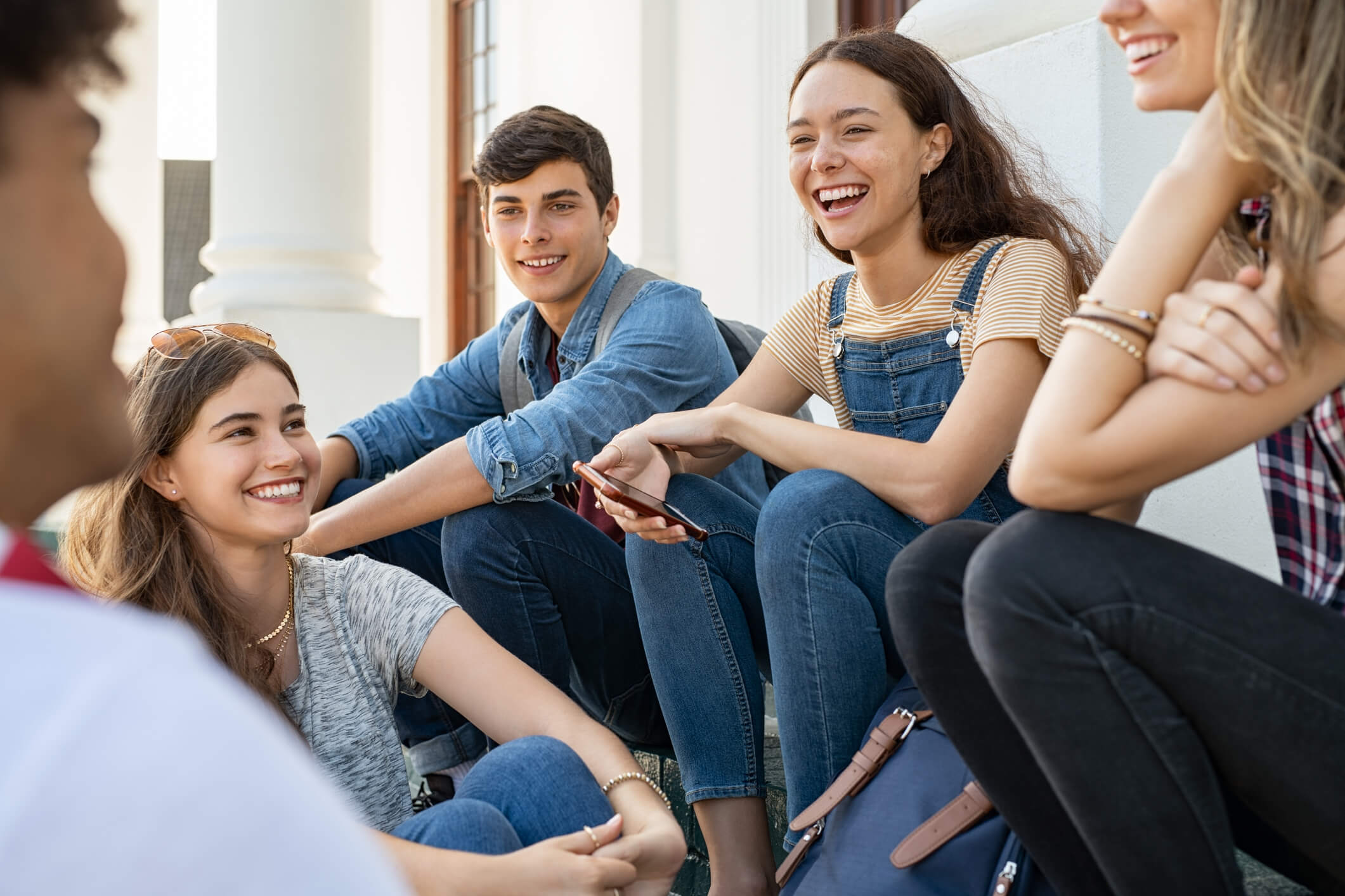 group of young people sitting and laughing