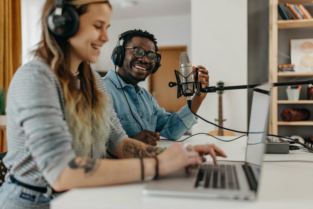 A man and a woman hosting a podcast.