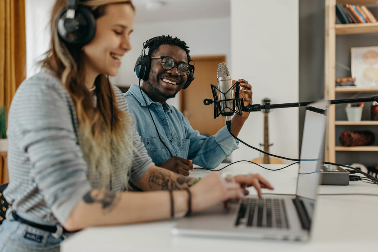 A man and a woman hosting a podcast.