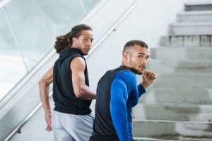 Two men running up steps.