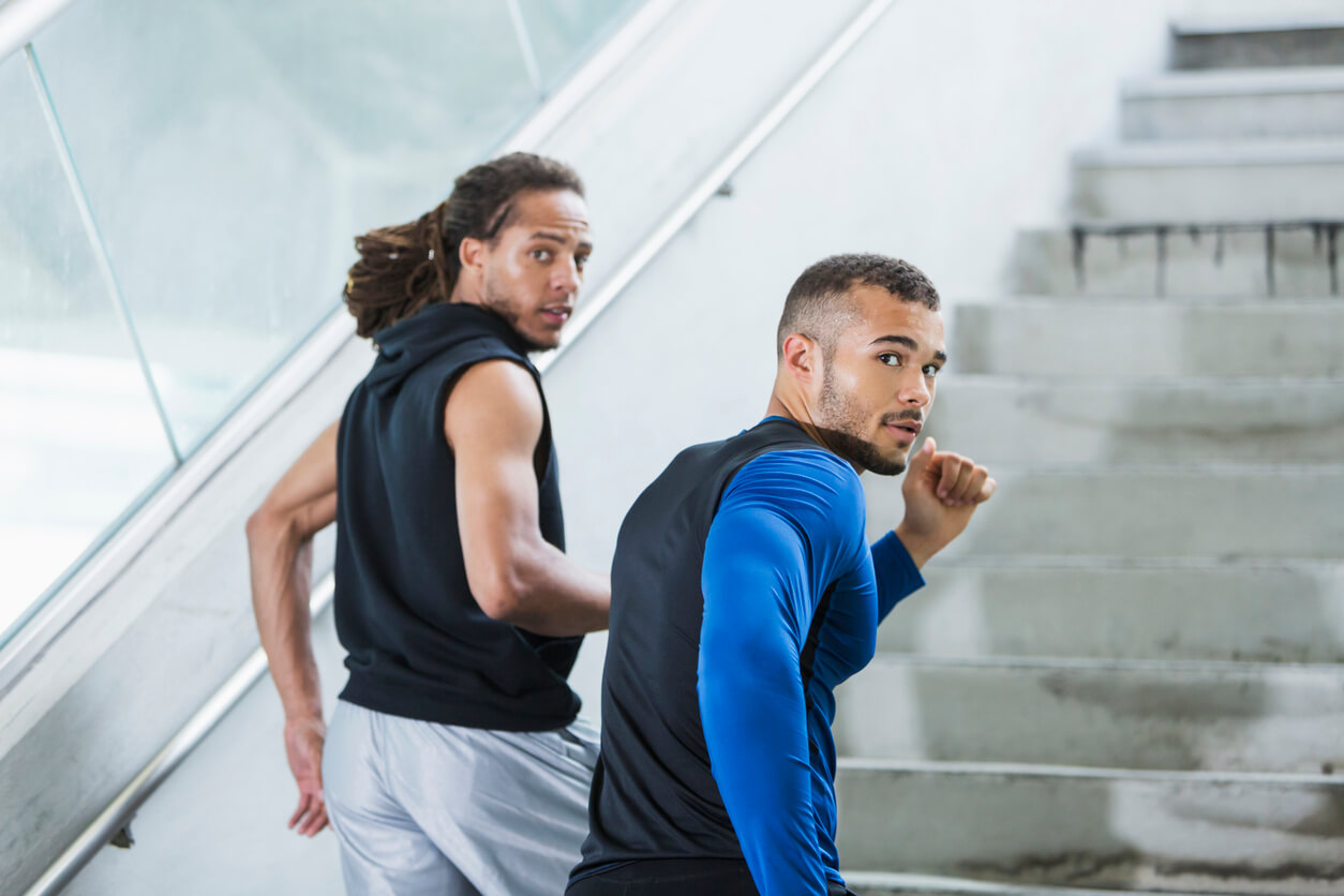 Two men running up steps.