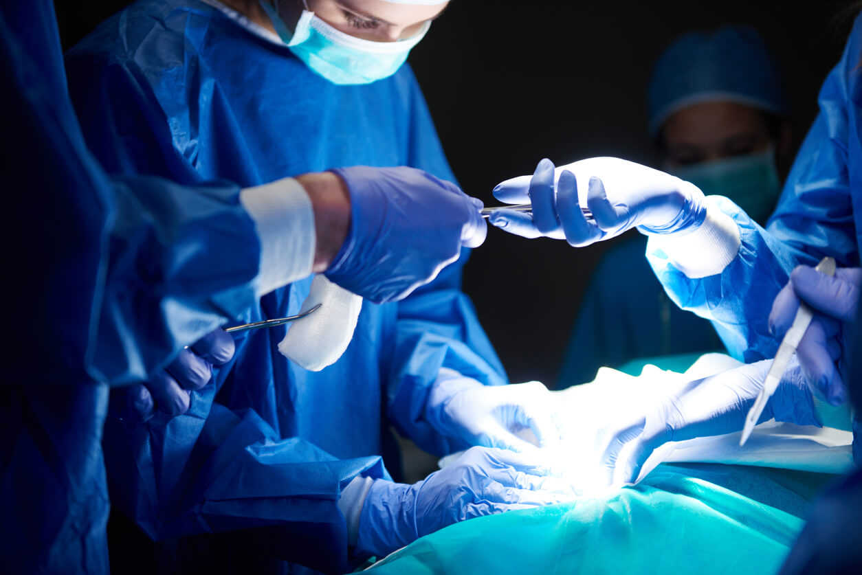 A group of surgeons around an operating table.