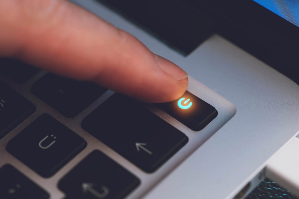 A finger powering off a computer.