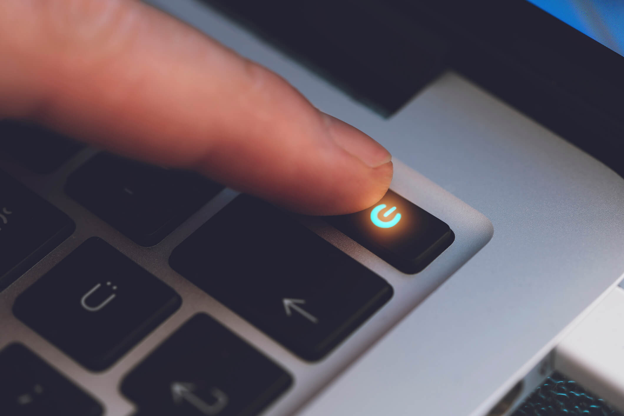 A finger powering off a computer.