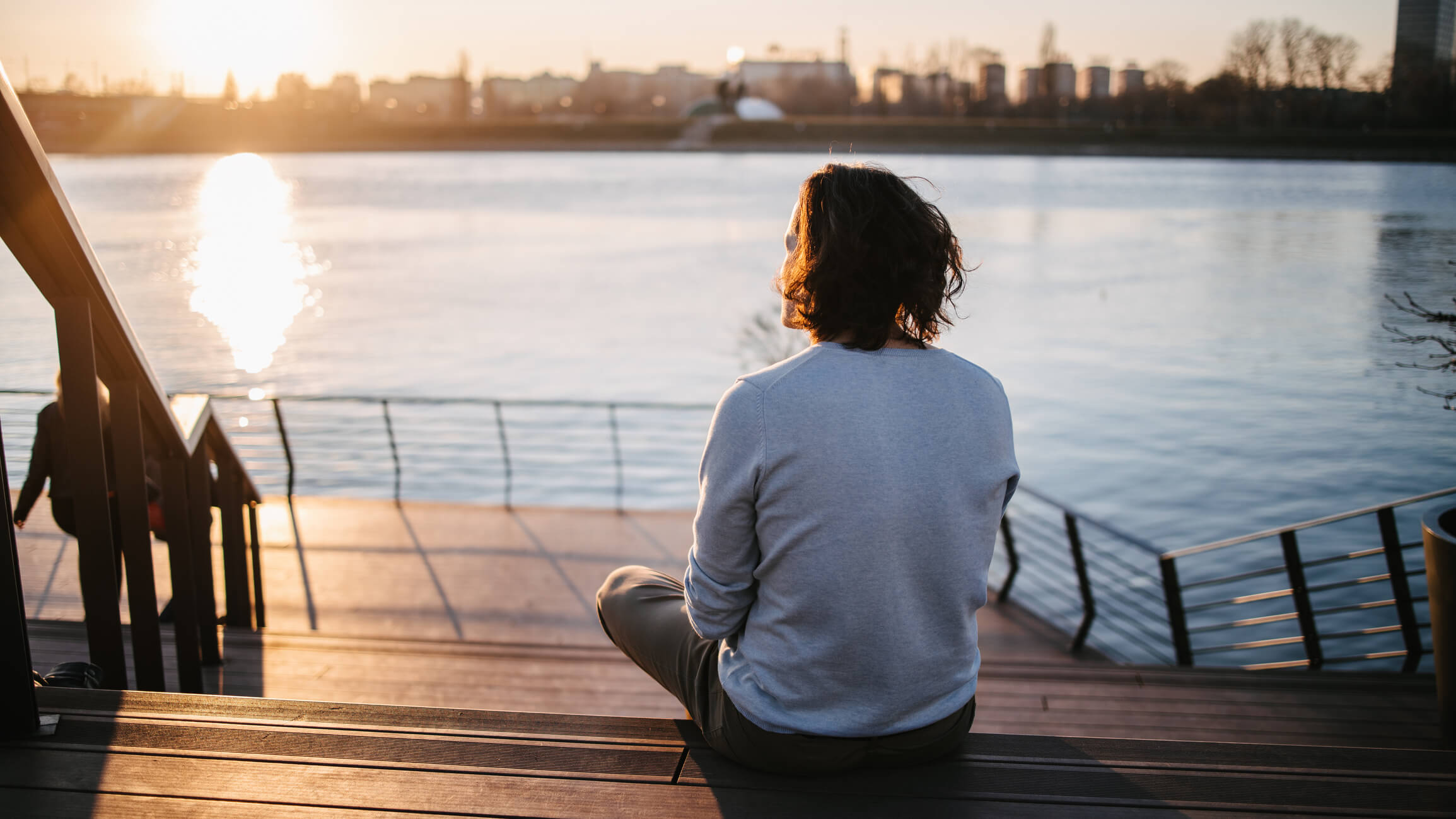 Man sitting by a river thinking about his freedom from porn.