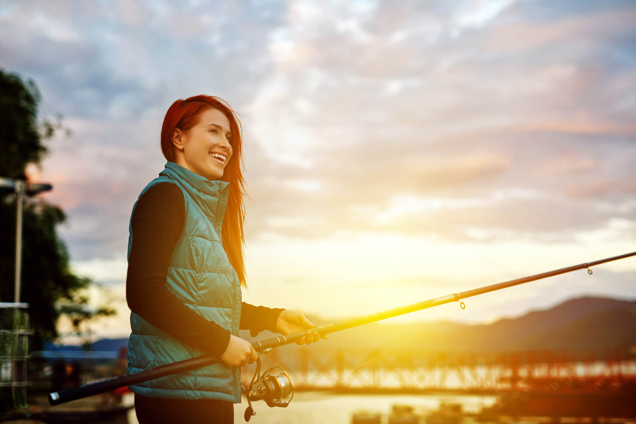 I woman going fishing at sunset.