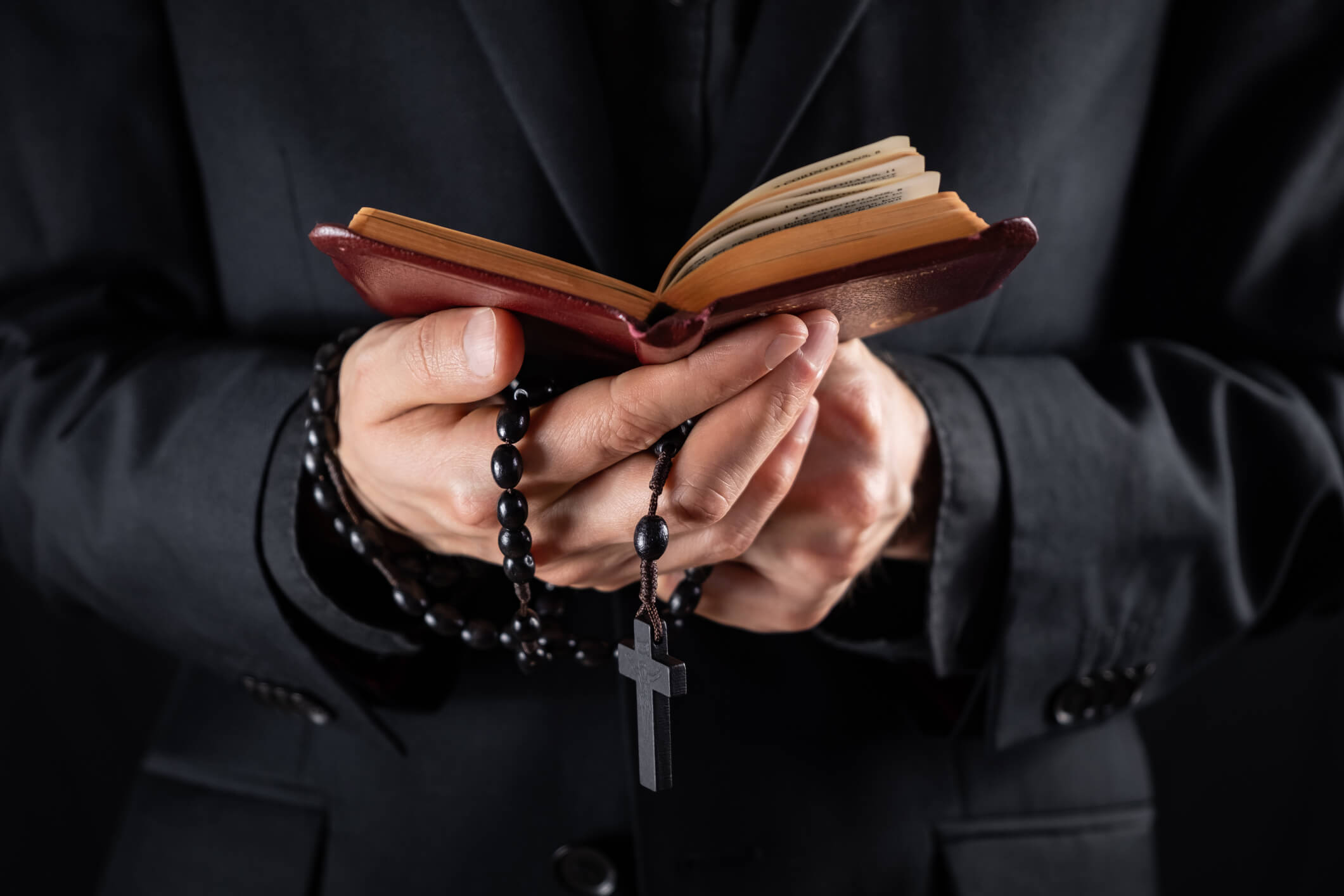 Priest with a Bible.