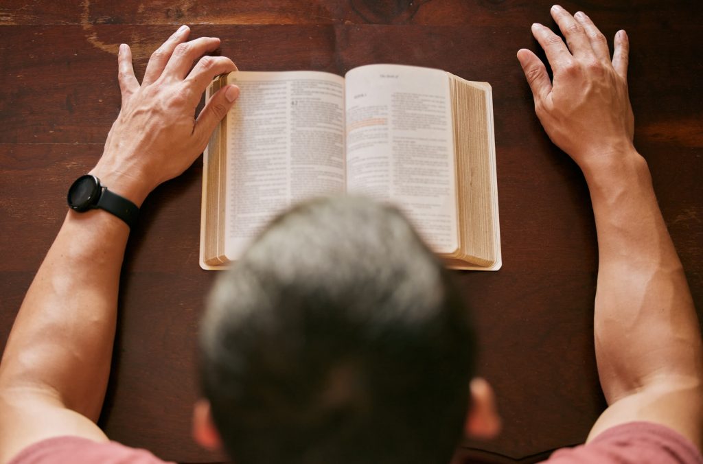 Man reading his Bible and worrying about hell.