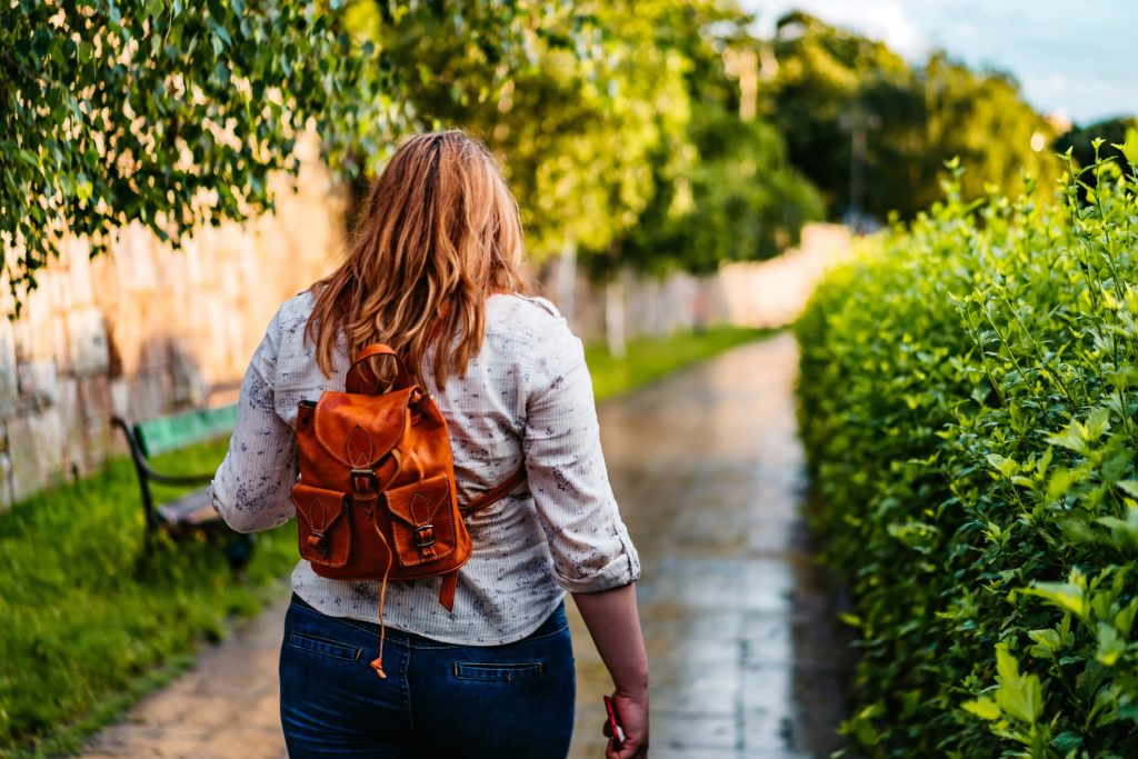 A young woman walking outside.