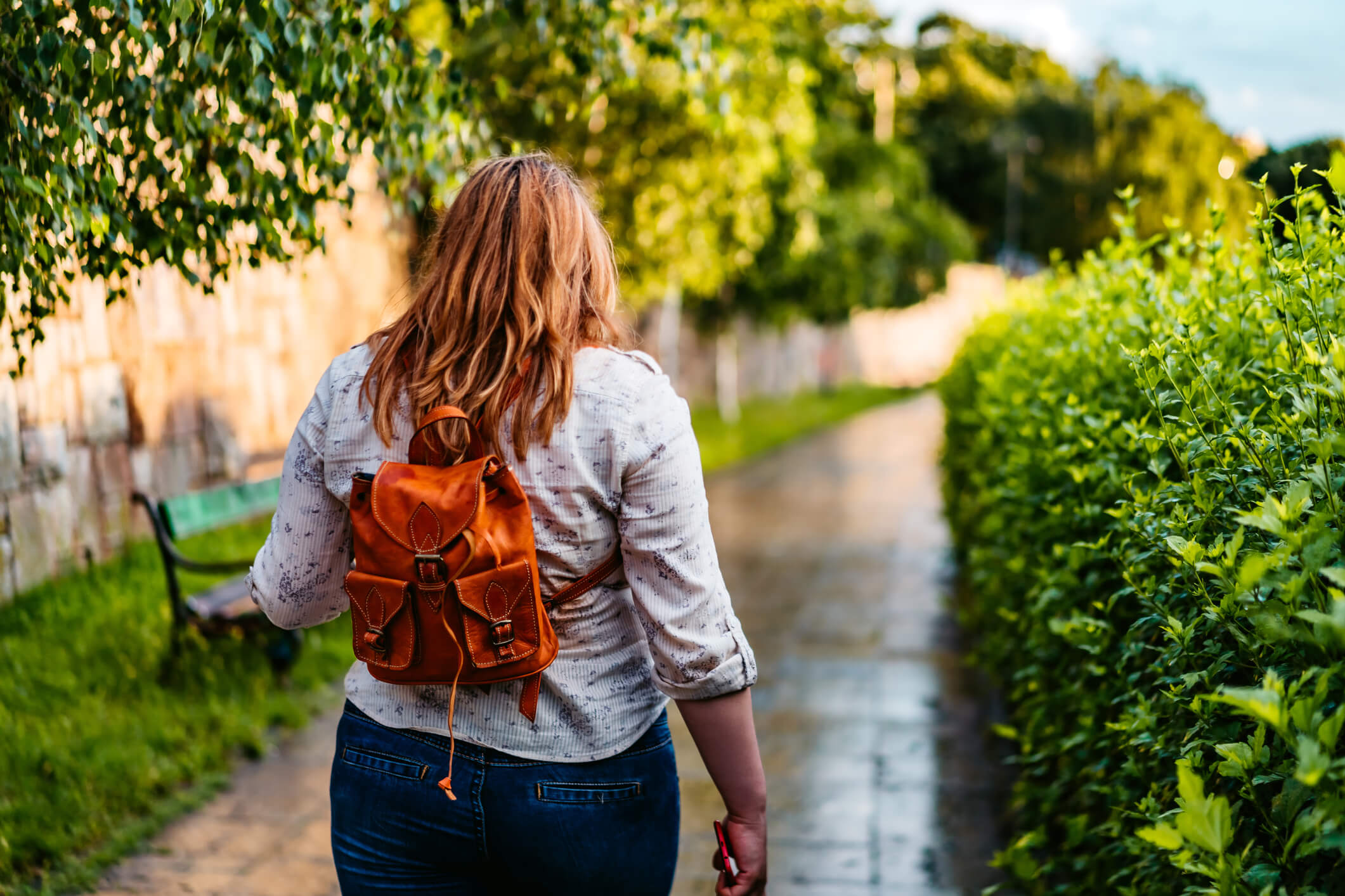 A young woman walking outside.