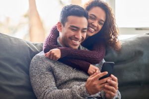 A couple looking at a phone together.