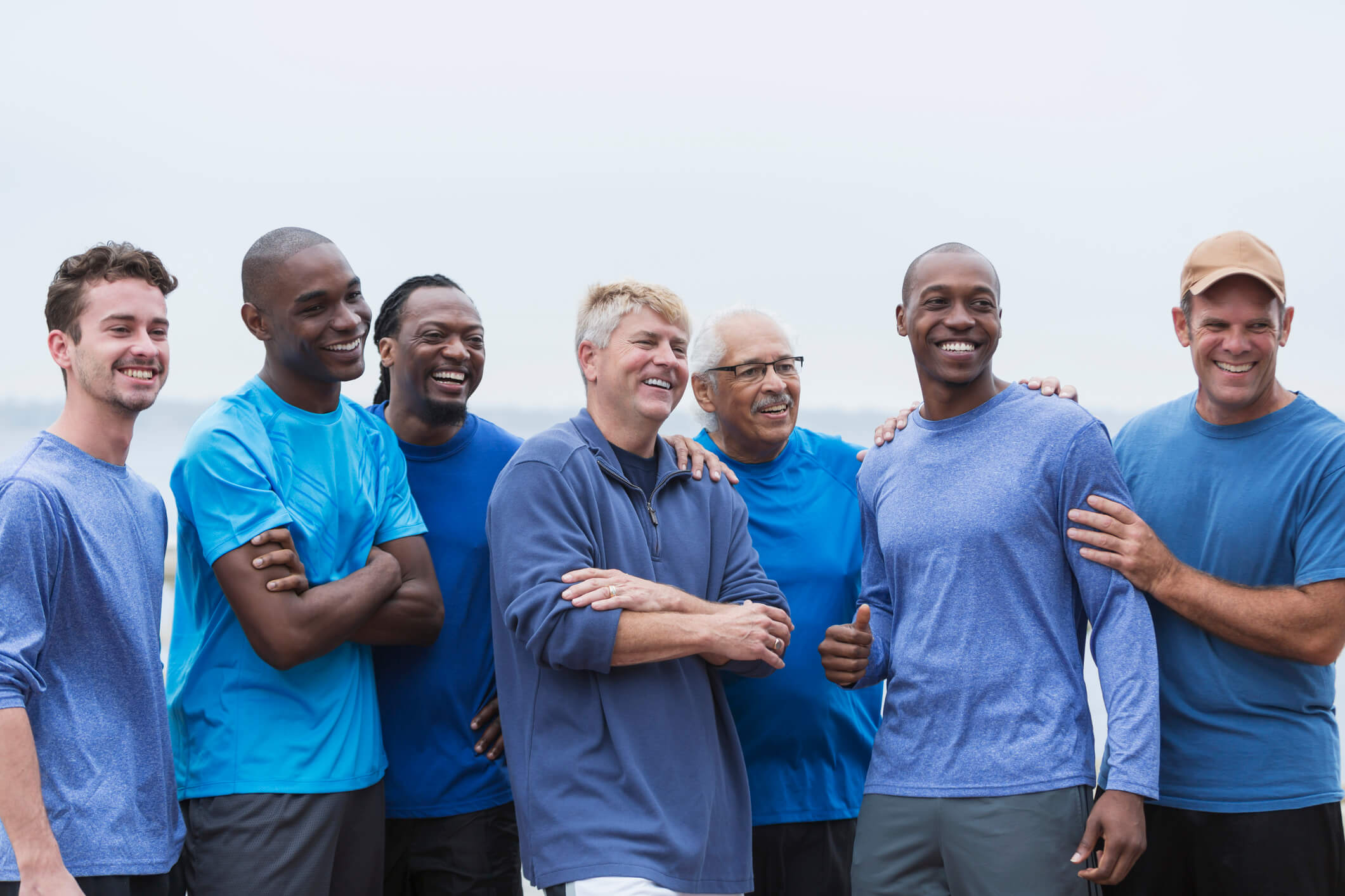 A men's ministry group standing outside laughing.