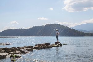 A man standing on a rock who is stuck.