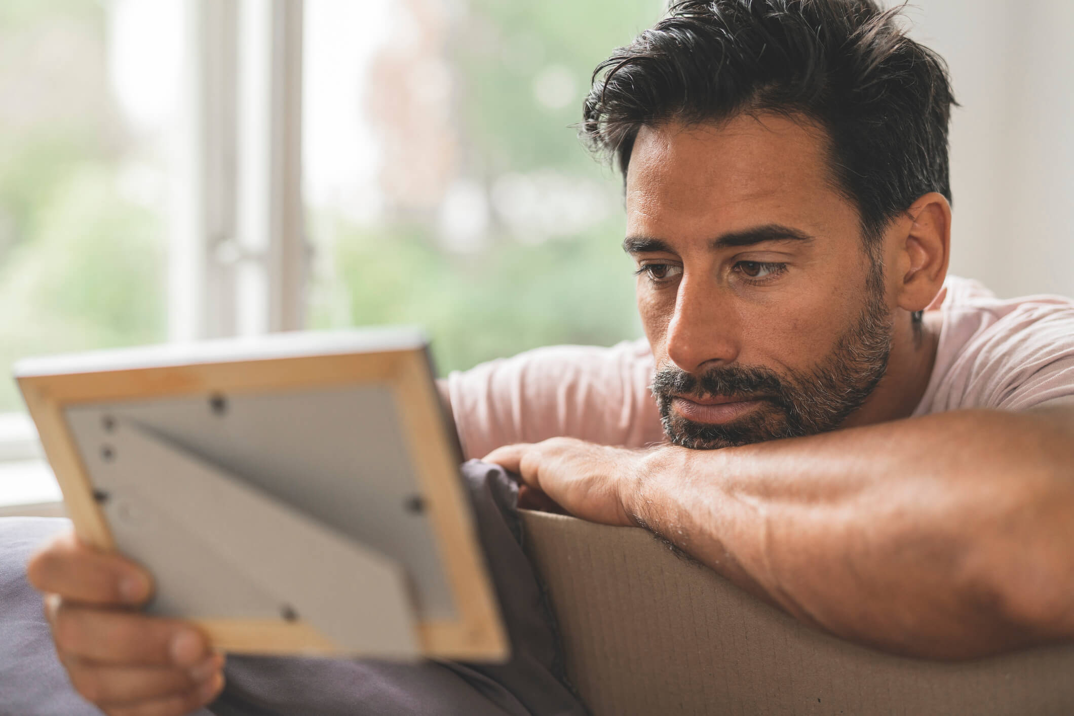 A man looking at a photo of his wife.