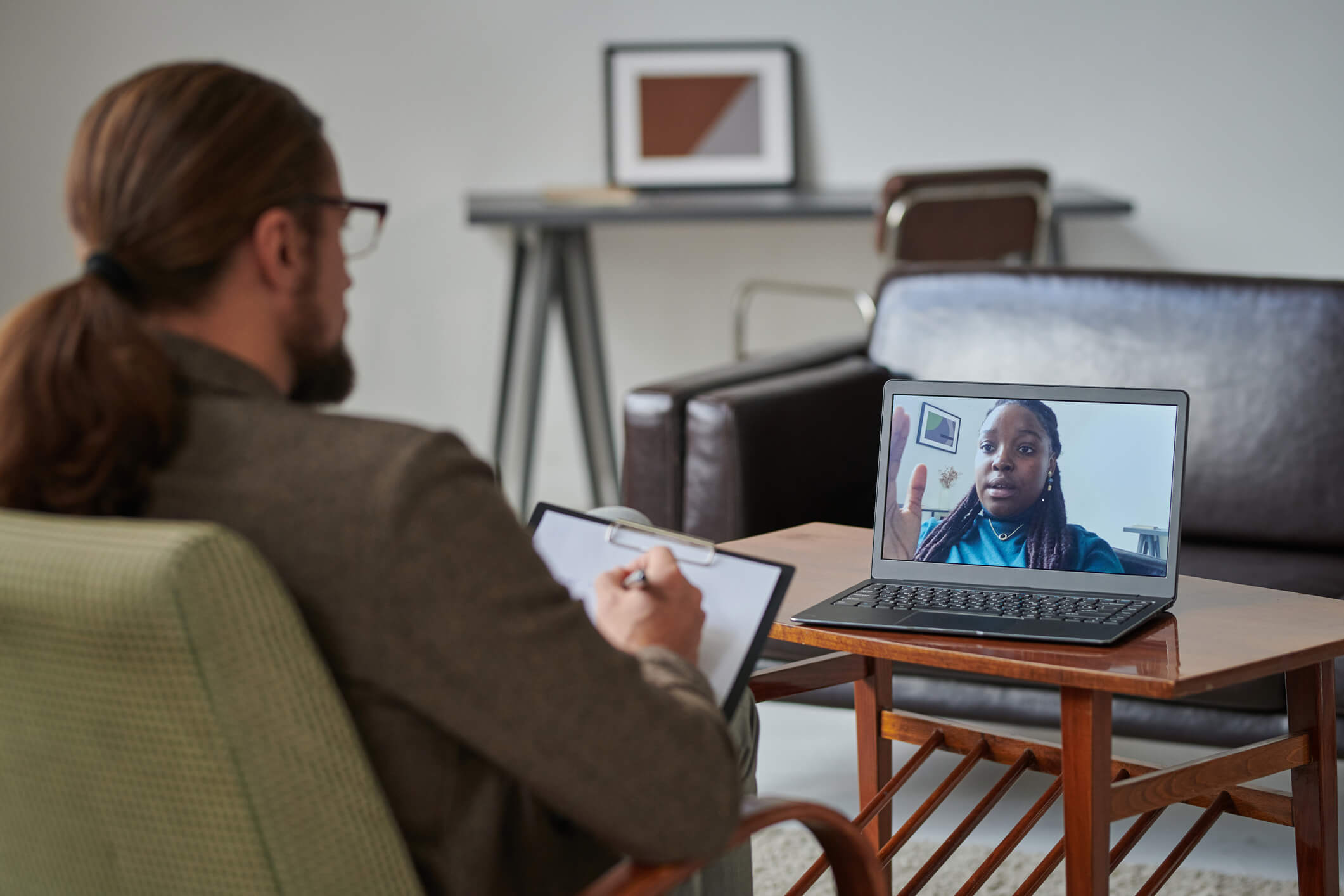 A counselor talking to a client on a video call.