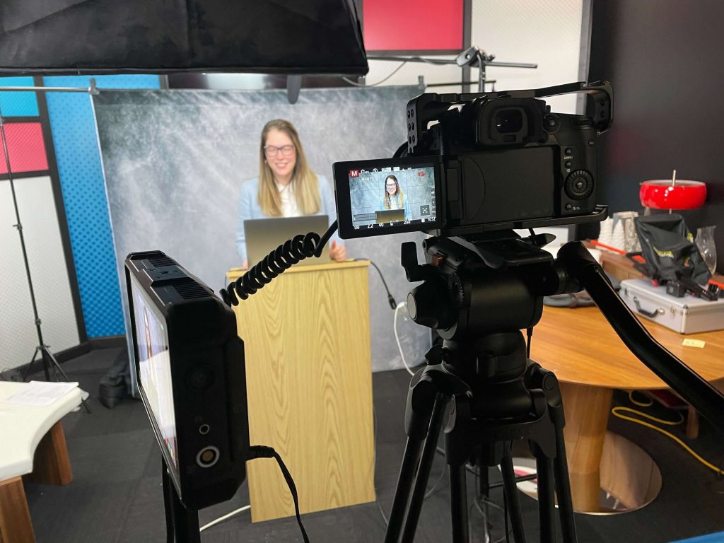 Amanda Zurface in studio preparing for a broadcast.