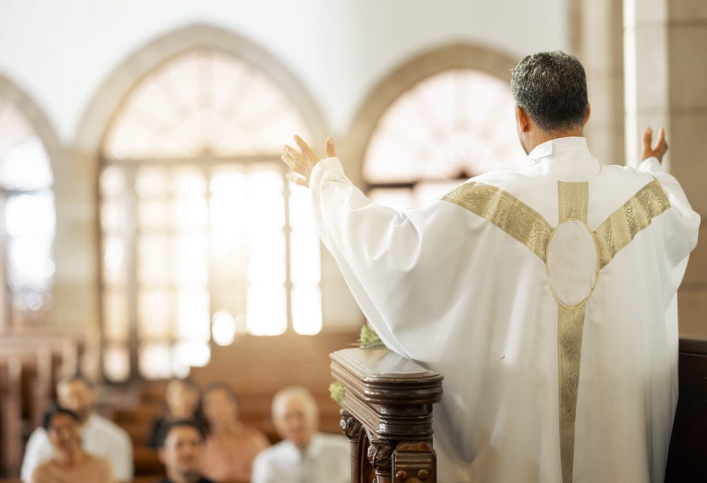 A priest giving a homily at his church.