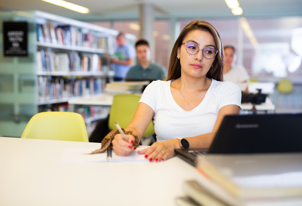 Female student writing a scholarship essay.