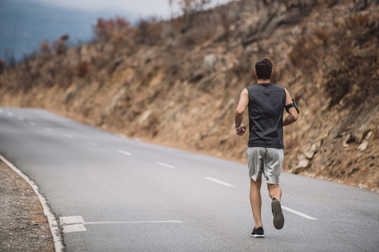 Male jogger running on the road.