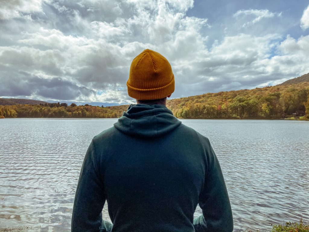 Man looking at a scenic lake.