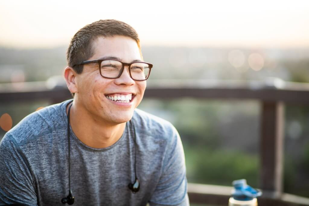 A young man smiling.