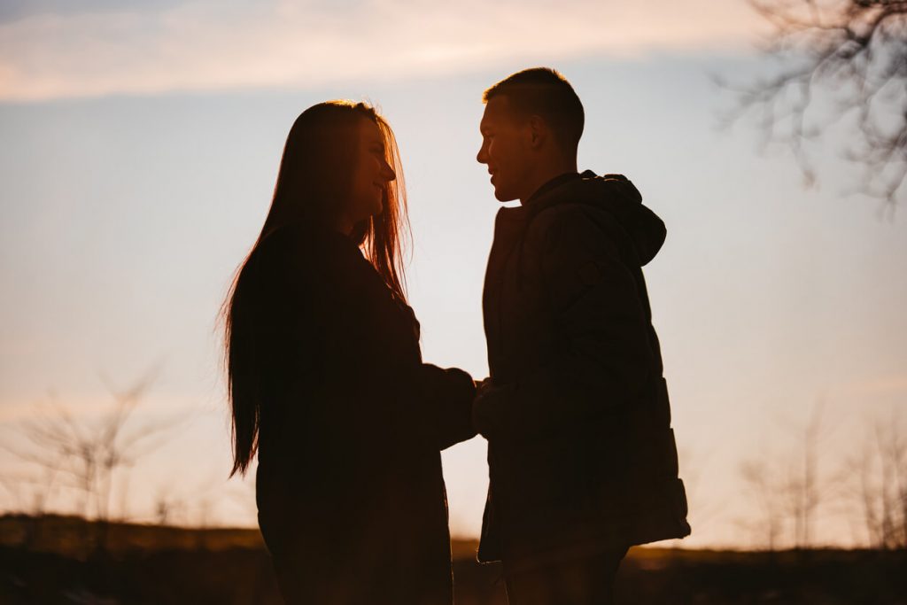 Silhouette of a young engaged couple.