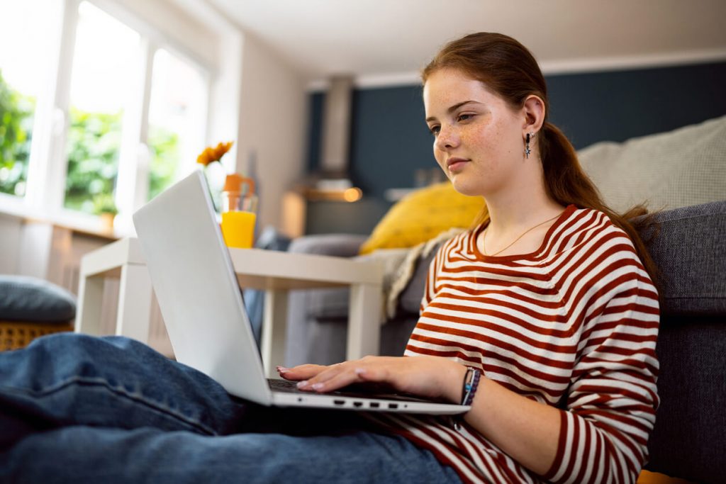 A teenage girl using a computer.