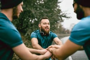 Three men preparing to go on a run.