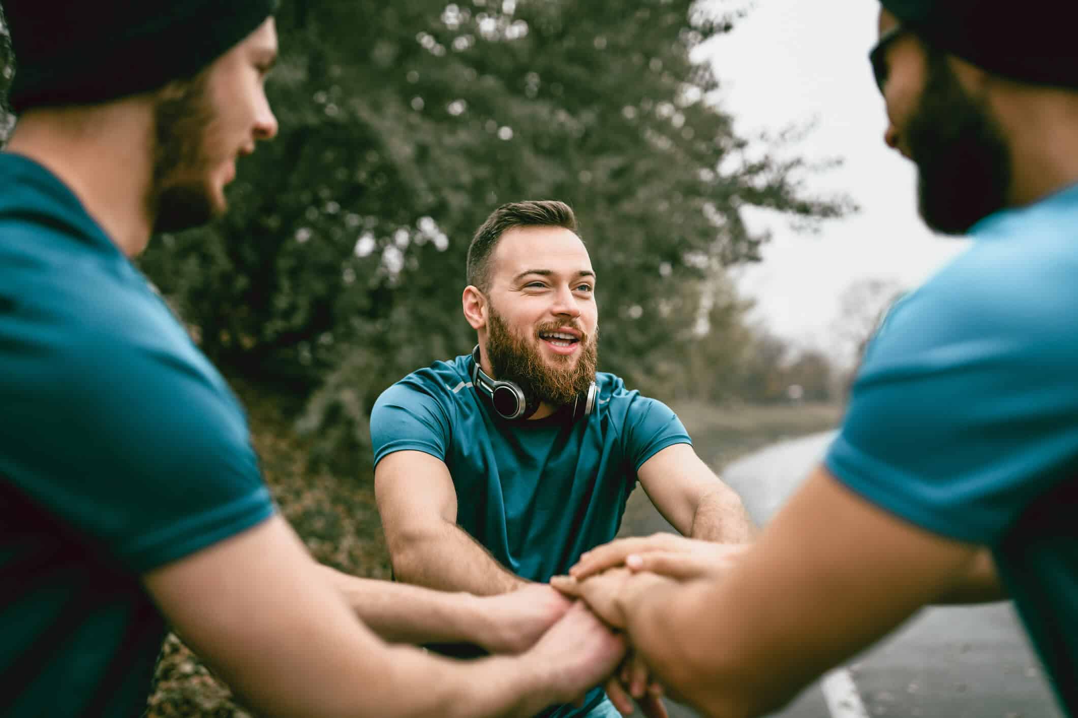 Three men preparing to go on a run.