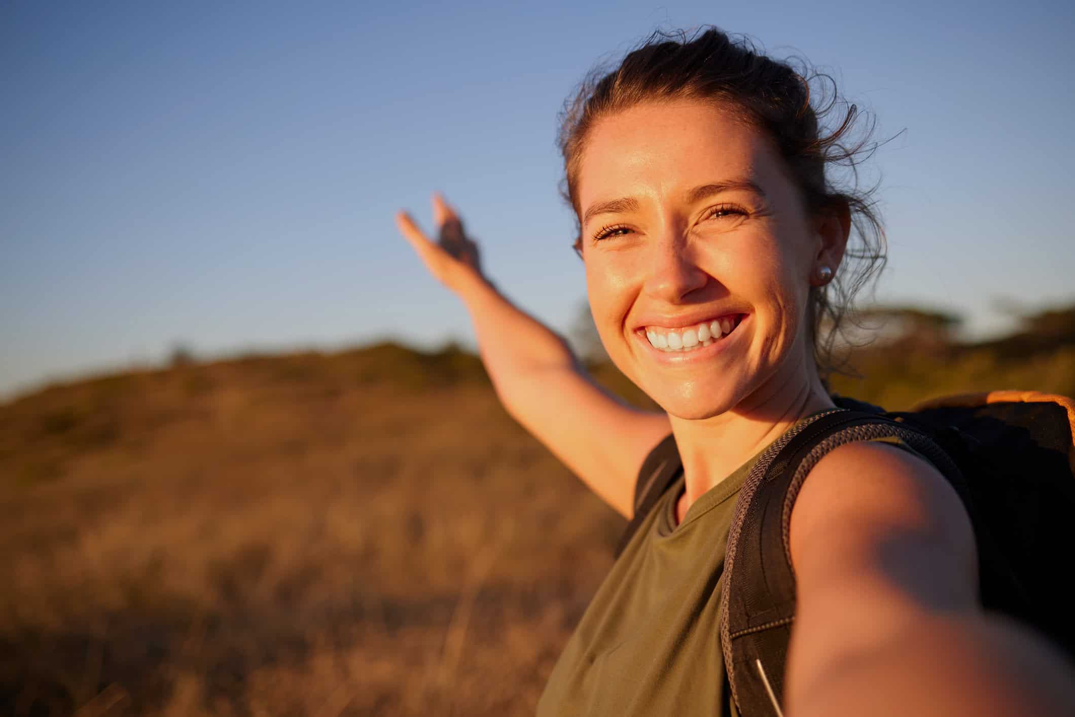 A happy young woman enjoying the outdoors.