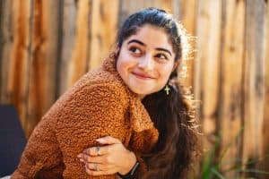 A thoughtful and smiling young woman.