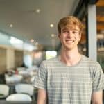 A smiling male college student.