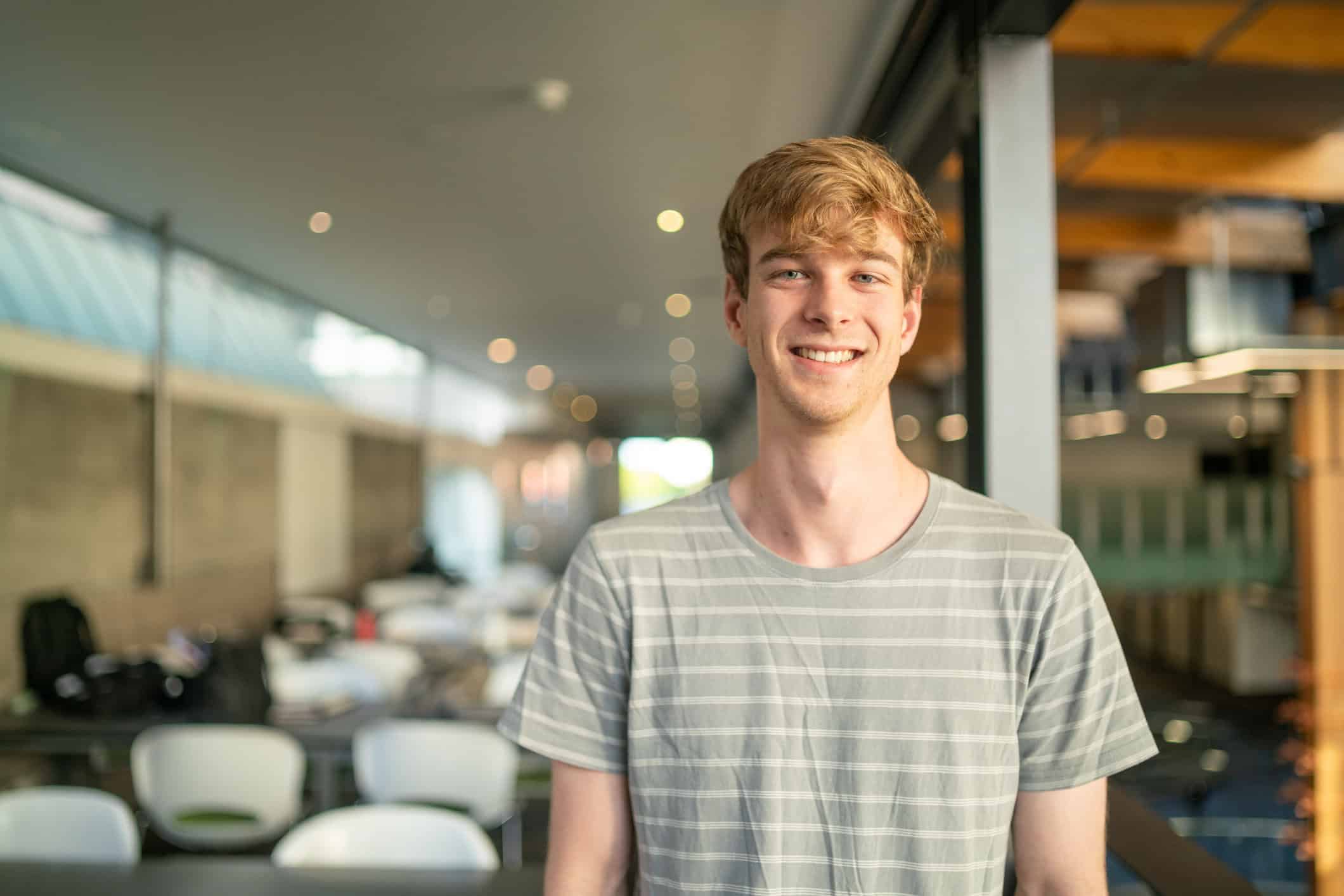 A smiling male college student.