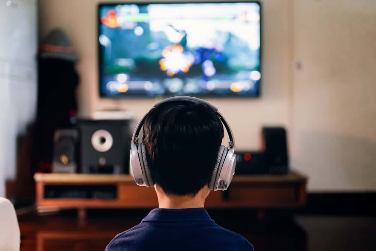 boy enjoying game console at home