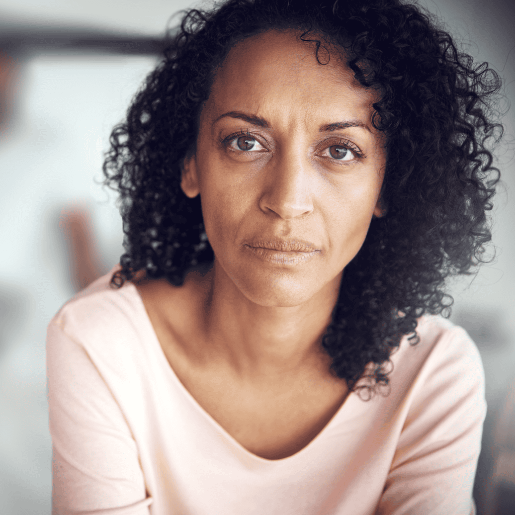 A woman stares directly forward.