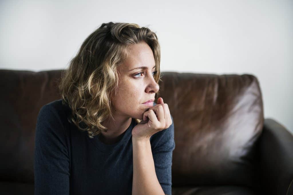 A woman looks into the distance.