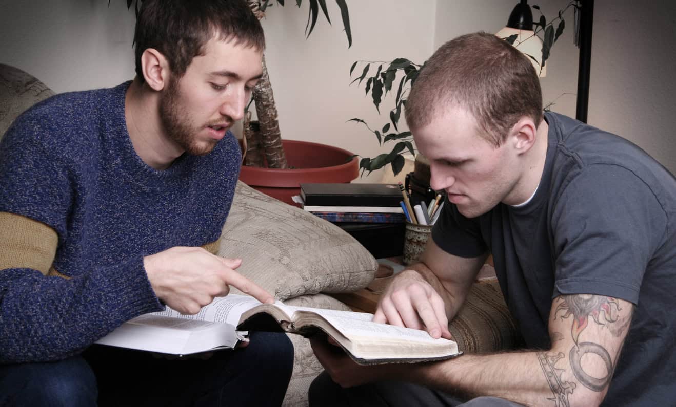 Two young men studying the Bible.
