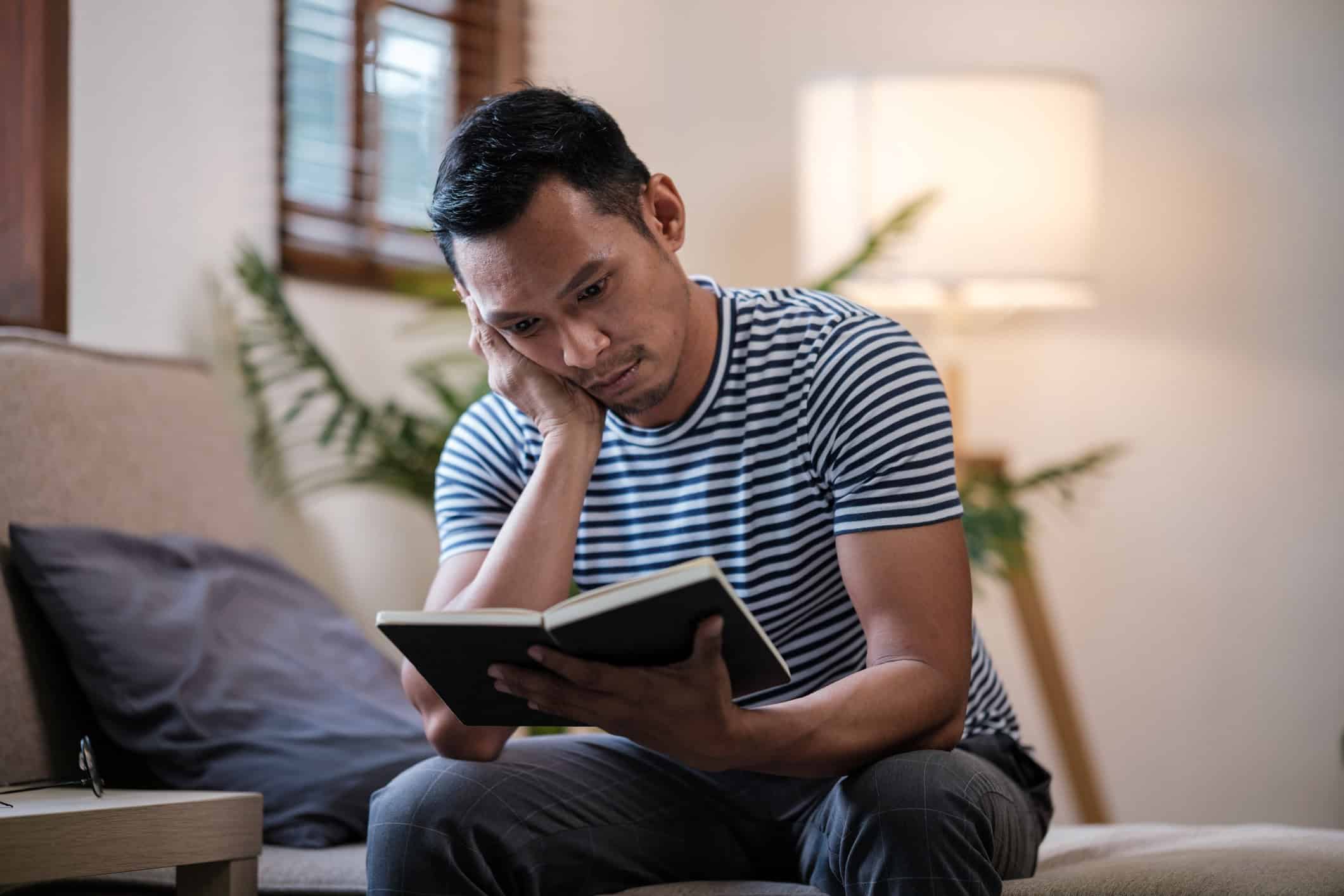 Man looking at his Bible.