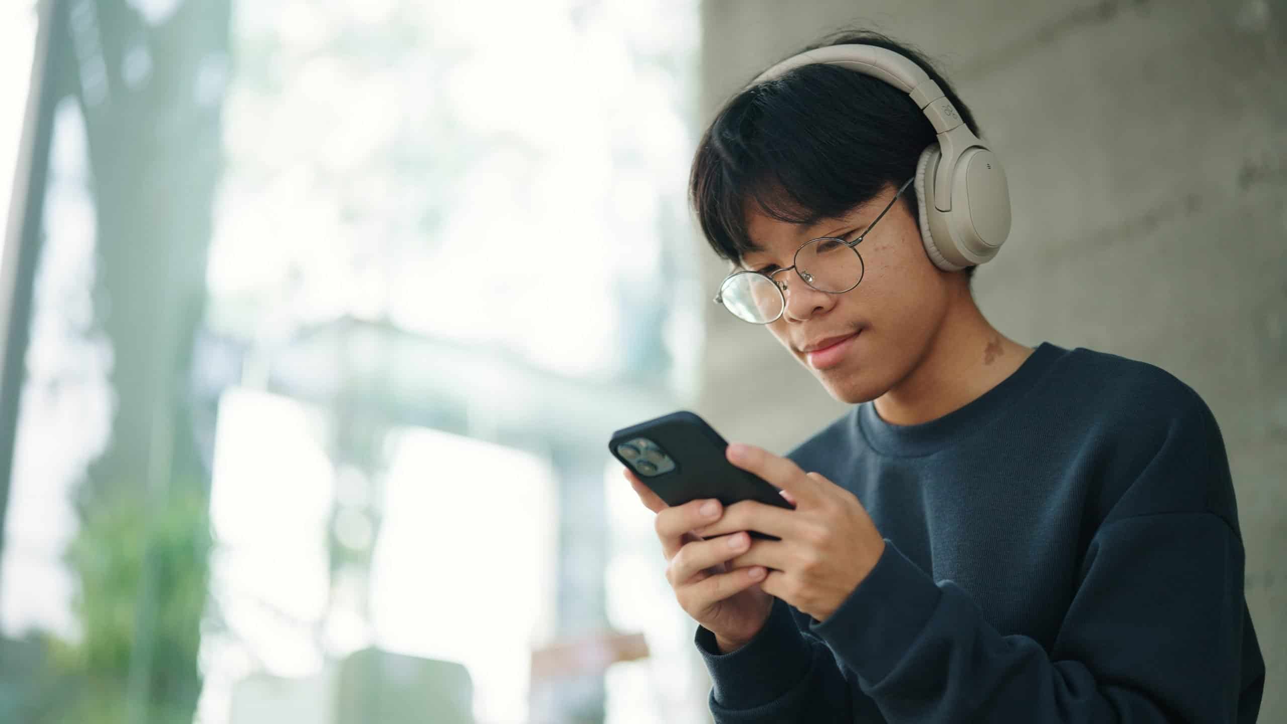 Teenager man using smartphone.