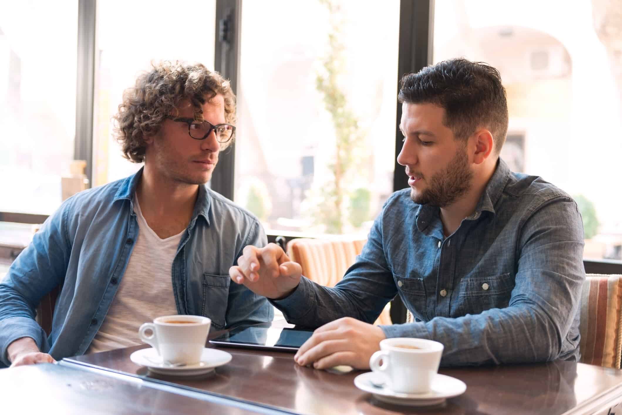 Two young men meeting for coffee.