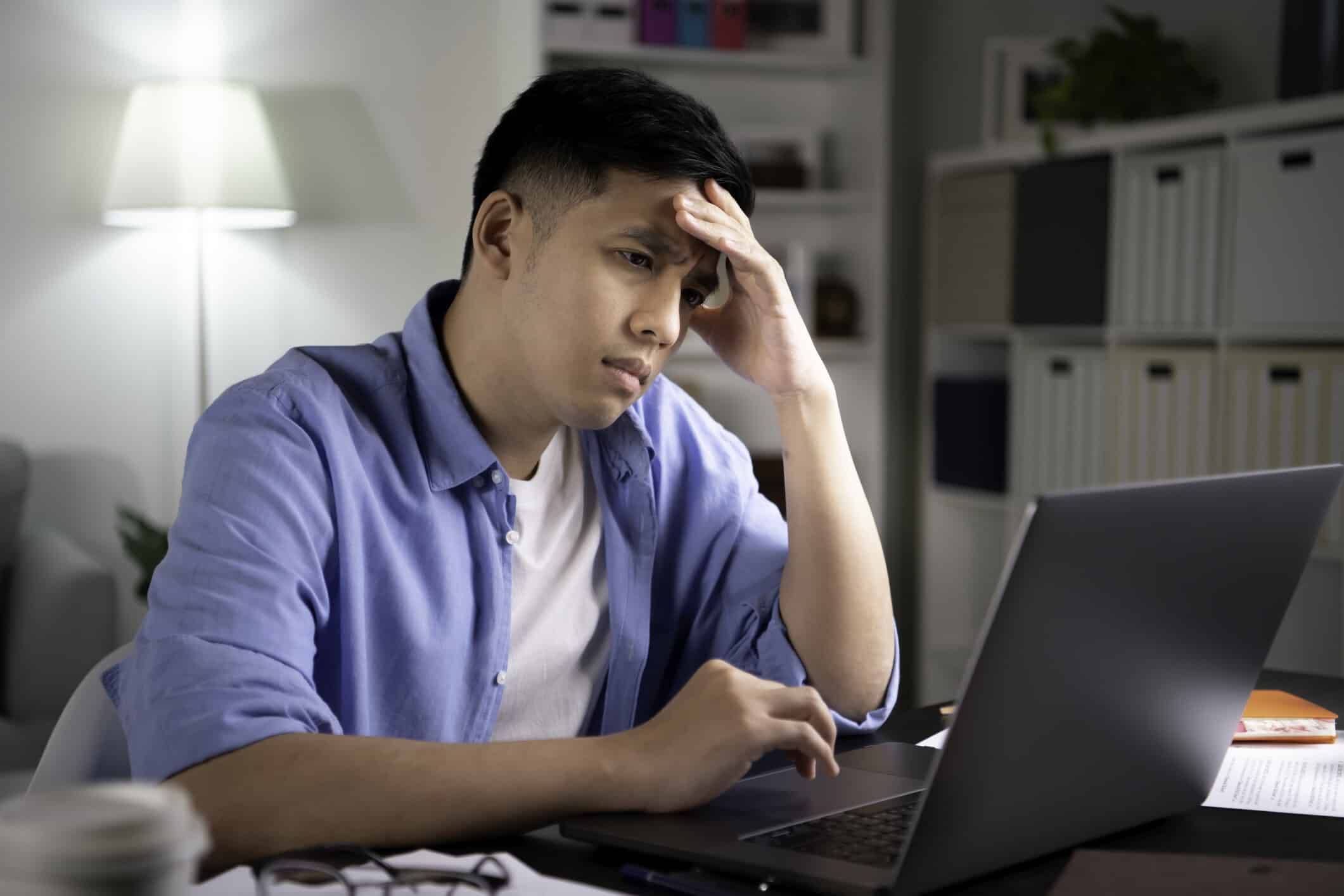 Concerned man looking at a computer screen.
