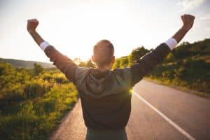 Man raising arms.