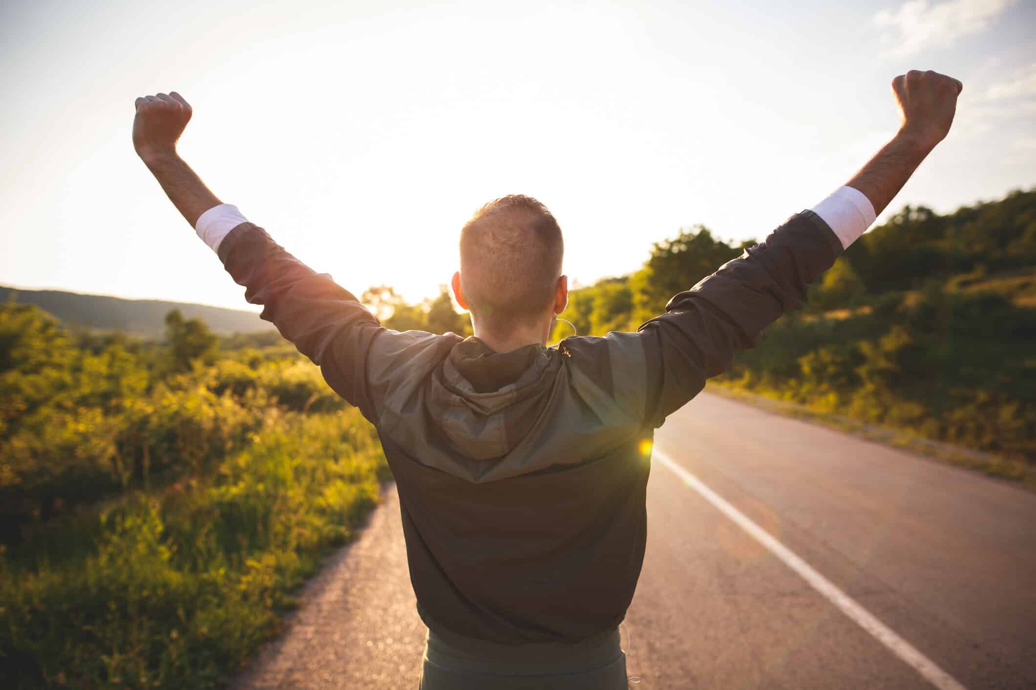Man raising arms.