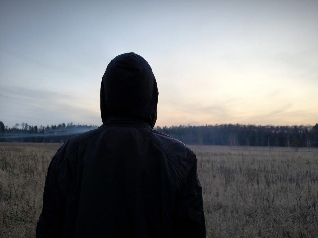 Young man looking at sunset.