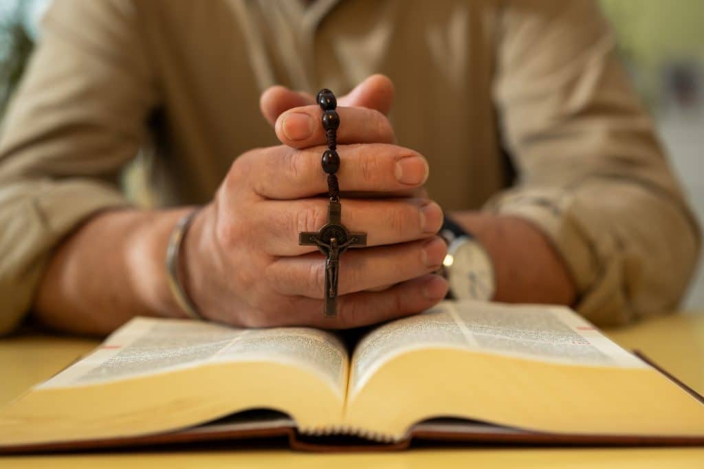 Man with a Bible and a cross.